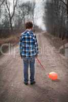 The sad boy with a balloon