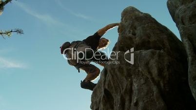 Rock climber scales high point two cam shot