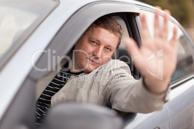 The man at the wheel the grey car