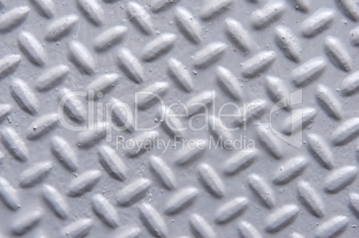 Closeup of Painted Metal Surface with Herringbone Pattern