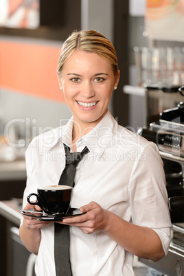 Young smiling waitress with cup of coffee