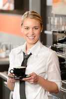 Young smiling waitress with cup of coffee