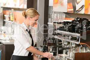 Waitress preparing hot beverage in coffee house
