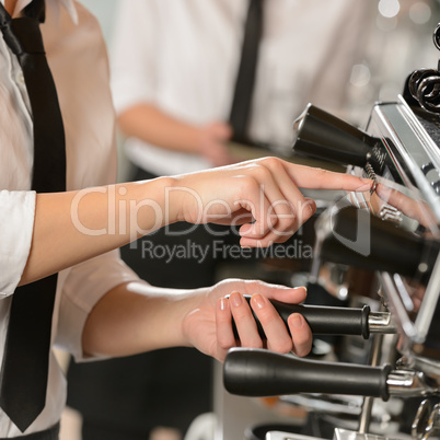 Waitress operating espresso machine coffee house
