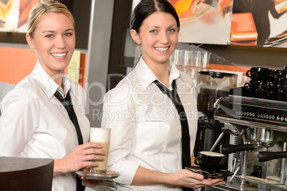 Cheerful waitresses serving hot coffee in bar