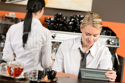 Happy waitresses working at cafe in uniform