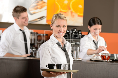 Confident waitress serving coffee with tray