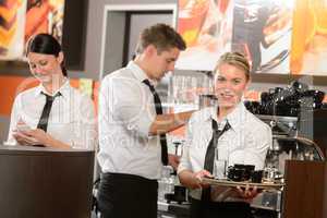 Confident waitresses and waiter working in bar