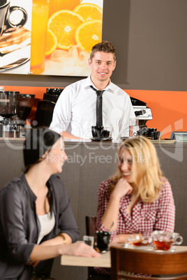 Attractive young bartender smiling in pub