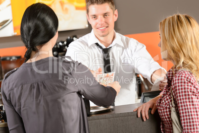 Female customers paying by cash CZK bar