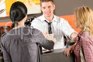 Female customers paying by cash CZK bar