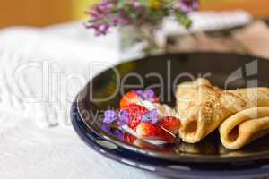 Pancakes, strawberries and cream