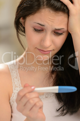 Distraught girl waiting for pregnancy test result