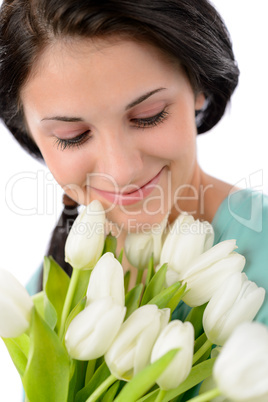 Smiling woman holding bouquet of white tulips