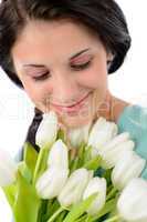 Smiling woman holding bouquet of white tulips