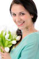 Cheerful young woman with bouquet of tulips