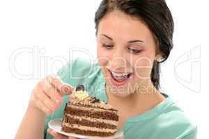Joyful girl eating tasty piece of cake
