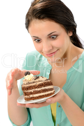 Tempting sweet cake and young hungry woman
