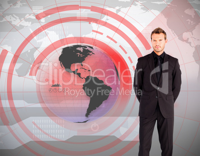 Businessman standing against global interface Businessman standing against global interface