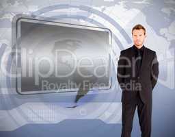 Businessman standing against blank screen