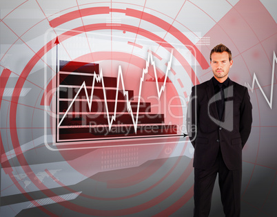 Businessman standing against graph display