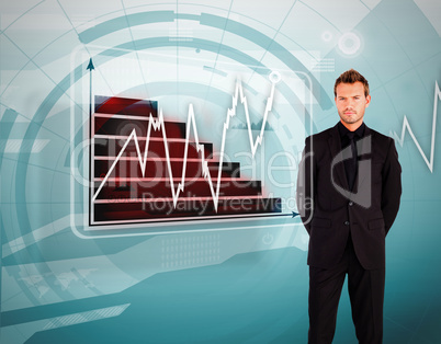 Businessman standing against graph and line display