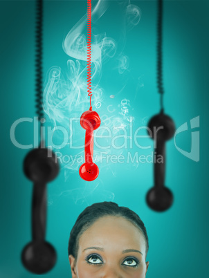 Woman looking up at hanging telephone receiver