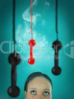 Woman looking up at hanging telephone receiver