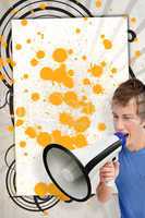 Young man shouting through megaphone in front of copy space with