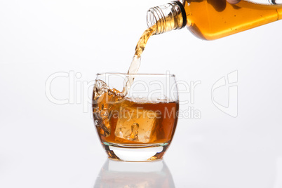 Whisky pouring into glass