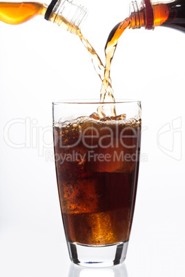 Soda and alcohol filling a glass with ice cube