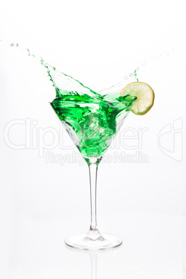 Cocktail glass with green alcohol and lemon