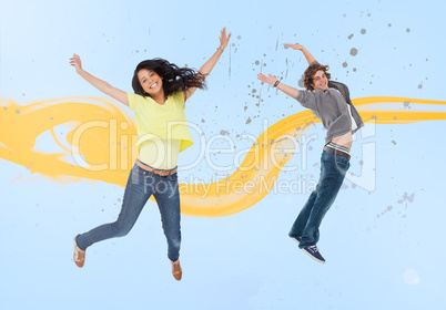 Attractive young man and woman jumping for joy