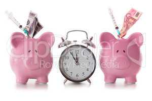 Dollar and euro notes and syringes sticking out of piggy banks w