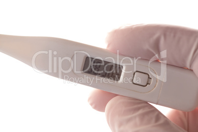 Gloved hand holding thermometer
