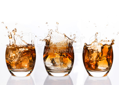 Serial arrangement of whiskey splashing in tumbler
