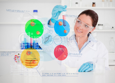 Smiling chemist looking at test tube