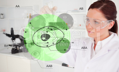 Chemist examining green cell interface