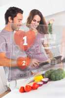 Smiling couple preparing dinner using futuristic interface