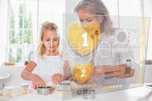 Grandmother and granddaughter baking with interface