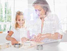 Grandmother and granddaughter baking with white interface
