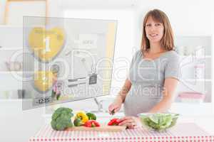 Pregnant woman making dinner using hologram interface