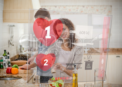 Happy couple making dinner using interface instructions