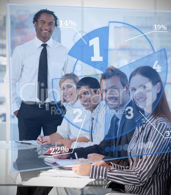 Smiling business people using blue pie chart interface