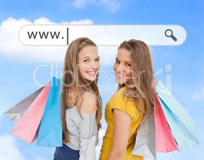 Smiling girls with their shopping bags under address bar