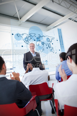 Business people clapping stakeholder standing in front of map di