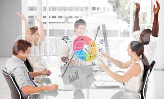Cheerful business workers using colorful pie chart interface
