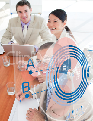 Overview of cheerful colleagues looking at blue chart interface