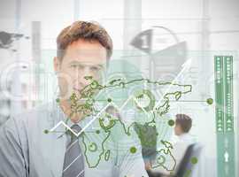 Businessman looking at green map interface