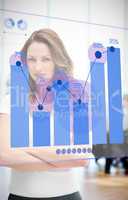 Confident businesswoman looking at blue diagram interface
